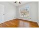 Cozy bedroom featuring hardwood floors and a window that provides natural light at 3211 Blaisdell Rd, Buford, GA 30519