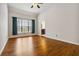 Bright bedroom with hardwood floors and a view to the backyard, creating a serene and comfortable space at 3211 Blaisdell Rd, Buford, GA 30519