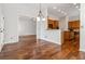 Open-concept dining area with hardwood floors, adjacent to kitchen and living spaces at 3211 Blaisdell Rd, Buford, GA 30519