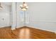 Elegant dining room with hardwood floors, featuring large windows that provide ample natural light and a cozy atmosphere at 3211 Blaisdell Rd, Buford, GA 30519