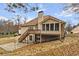 Rear exterior with deck, sunroom, and gravel landscaping at 3211 Blaisdell Rd, Buford, GA 30519