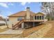 Back exterior with spacious yard, deck, sunroom, and chimney at 3211 Blaisdell Rd, Buford, GA 30519