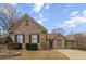 Charming single-story brick home with manicured landscaping and a well-maintained lawn, perfect for suburban living at 3211 Blaisdell Rd, Buford, GA 30519