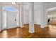 Bright foyer with gleaming hardwood floors, showcasing elegant columns and a welcoming entrance to the home at 3211 Blaisdell Rd, Buford, GA 30519