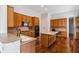 Spacious kitchen with wood cabinets, stainless steel appliances, hardwood floors and central island at 3211 Blaisdell Rd, Buford, GA 30519