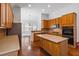 Large kitchen boasting wood cabinets, stainless steel appliances, hardwood floors and center island at 3211 Blaisdell Rd, Buford, GA 30519