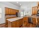 Spacious kitchen featuring wood cabinets, stainless steel appliances, hardwood floors and center island at 3211 Blaisdell Rd, Buford, GA 30519