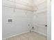 Functional laundry room featuring tiled floor and white wire shelving at 3211 Blaisdell Rd, Buford, GA 30519