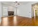 Inviting living room with hardwood floors and a classic fireplace, offering a comfortable and stylish living space at 3211 Blaisdell Rd, Buford, GA 30519