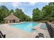 Large community pool with a pool house and various seating arrangements at 3211 Blaisdell Rd, Buford, GA 30519