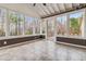 Cozy sunroom with tiled floor, multiple windows, and backyard views at 3211 Blaisdell Rd, Buford, GA 30519