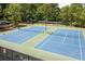 Aerial view of community tennis courts surrounded by mature trees at 3211 Blaisdell Rd, Buford, GA 30519