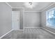 Bright bedroom with updated carpet, a large window, and neutral color palette at , Atlanta, GA 30315
