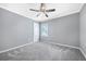 Clean and simple bedroom with neutral walls, carpet, a ceiling fan, and a window for natural light at , Atlanta, GA 30315