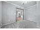 View of open concept living room with grey walls and carpet leading to a spacious kitchen with stainless steel appliances at , Atlanta, GA 30315