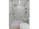 Beautiful bathroom with gray tiled walk-in shower with rainfall shower head and bench at 1508 Wingate Way, Atlanta, GA 30350
