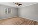 Comfortable bedroom featuring hardwood floors, a ceiling fan and a large window with natural light at 1508 Wingate Way, Atlanta, GA 30350