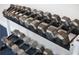 A range of metal dumbbells organized by weight on a two-tier rack in the gym at 1508 Wingate Way, Atlanta, GA 30350
