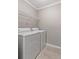 Convenient laundry room featuring a full size washer and dryer with bright overhead shelving at 1508 Wingate Way, Atlanta, GA 30350