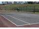 Outdoor tennis court with a high net, ready for a game at 1508 Wingate Way, Atlanta, GA 30350