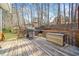 Outdoor wooden deck includes a stainless steel gas grill, a charcoal grill and outdoor seating at 2285 Briarwood Trl, Cumming, GA 30041