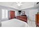 Spacious bedroom featuring neutral carpet, tray ceiling, and abundant natural light at 2285 Briarwood Trl, Cumming, GA 30041