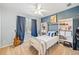 Cozy bedroom with blue accent wall, white shelving, and ample natural light from the window at 2285 Briarwood Trl, Cumming, GA 30041
