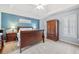 Spacious bedroom featuring neutral carpet, tray ceiling, and abundant natural light at 2285 Briarwood Trl, Cumming, GA 30041
