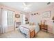 Comfortable bedroom with neutral carpet, pink walls, white shutters, and ceiling fan at 2285 Briarwood Trl, Cumming, GA 30041