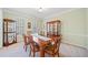 Elegant dining room with hardwood furniture, china cabinets, and natural light from the windows at 2285 Briarwood Trl, Cumming, GA 30041