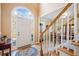Bright foyer with hardwood floors, staircase, and an arched window above the front door at 2285 Briarwood Trl, Cumming, GA 30041