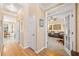 Hallway leading to office and dining room featuring beautiful hardwood floors and neutral paint at 2285 Briarwood Trl, Cumming, GA 30041
