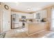 Bright kitchen boasts white cabinets, stainless steel appliances, granite countertops, and stylish tiled flooring at 2285 Briarwood Trl, Cumming, GA 30041