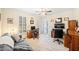 Well-lit home office with multiple desks, a sofa, and large windows with wooden shutters at 2285 Briarwood Trl, Cumming, GA 30041