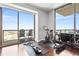 Workout area with a spin bike, weights, and a stunning city view from floor-to-ceiling windows at 270 17Th Nw St # 4208, Atlanta, GA 30363