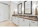Bathroom featuring dual sinks, granite countertop, and generous vanity storage at 270 17Th Nw St # 4208, Atlanta, GA 30363