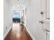 Hallway with hardwood floors leading to an open living area featuring a wall of windows and modern decor at 270 17Th Nw St # 4208, Atlanta, GA 30363
