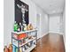 Hallway leading to a bar area with a giraffe artwork and a fully stocked bar cart, enhanced by hardwood floors at 270 17Th Nw St # 4208, Atlanta, GA 30363
