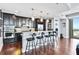 Modern kitchen featuring stainless steel appliances, granite countertops, a breakfast bar, and dark wood cabinets at 270 17Th Nw St # 4208, Atlanta, GA 30363