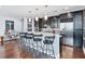 Modern kitchen featuring dark cabinets, stainless steel appliances, and a granite island with seating at 270 17Th Nw St # 4208, Atlanta, GA 30363