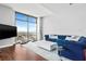 Living room with a plush sectional sofa, floor-to-ceiling windows, hardwood floors and a marble-topped coffee table at 270 17Th Nw St # 4208, Atlanta, GA 30363