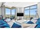 Living room with a plush sectional sofa and floor-to-ceiling windows offering panoramic views from the balcony at 270 17Th Nw St # 4208, Atlanta, GA 30363