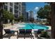 The condo complex outdoor pool provides a peaceful escape with relaxing lounge chairs, shade, and lush greenery all around at 270 17Th Nw St # 4208, Atlanta, GA 30363