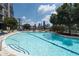 A condo complex outdoor pool offers clear blue water, a great view of the Atlanta skyline, and comfortable lounge chairs at 270 17Th Nw St # 4208, Atlanta, GA 30363