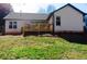 Backyard view features a wooden deck, well maintained lawn, and white painted exterior at 3065 Wildflower Ln, Snellville, GA 30039