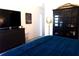 This primary bedroom has a large TV, storage cabinet, and a rustic lamp for warm interior lighting at 3065 Wildflower Ln, Snellville, GA 30039