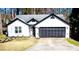 Charming single-story home featuring black trim, a gray roof, and a two-car garage at 3065 Wildflower Ln, Snellville, GA 30039