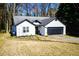 Charming single-story home featuring black trim, a gray roof, and a two-car garage at 3065 Wildflower Ln, Snellville, GA 30039