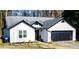 Charming single-story home featuring black trim, a gray roof, and a two-car garage at 3065 Wildflower Ln, Snellville, GA 30039