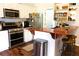 Well-equipped kitchen with stainless steel appliances, granite countertops, and breakfast bar at 3065 Wildflower Ln, Snellville, GA 30039